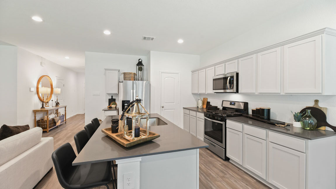 Kitchen with an island and vinyl floor