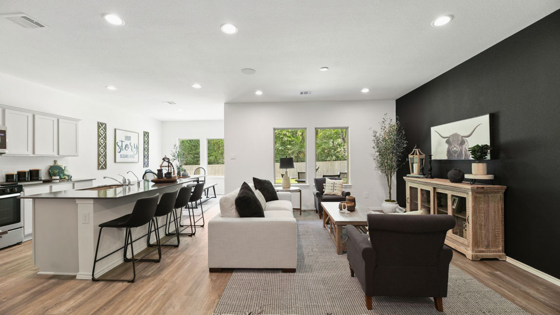 Spacious living area with vinyl flooring