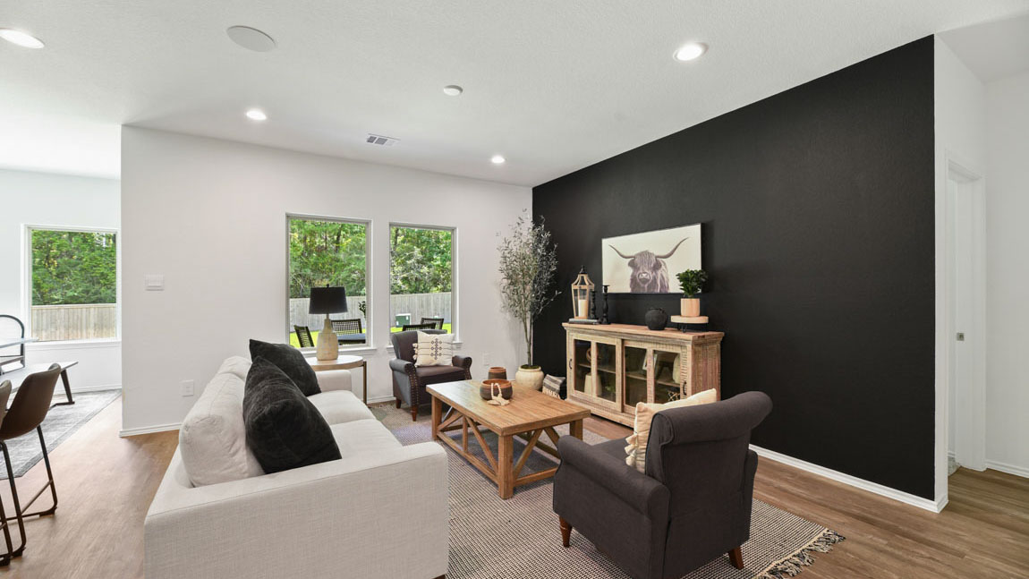 Spacious living area with vinyl flooring