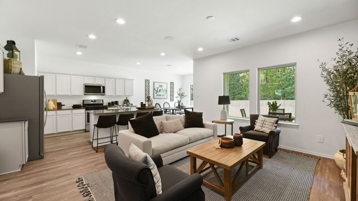 Spacious living area with vinyl flooring