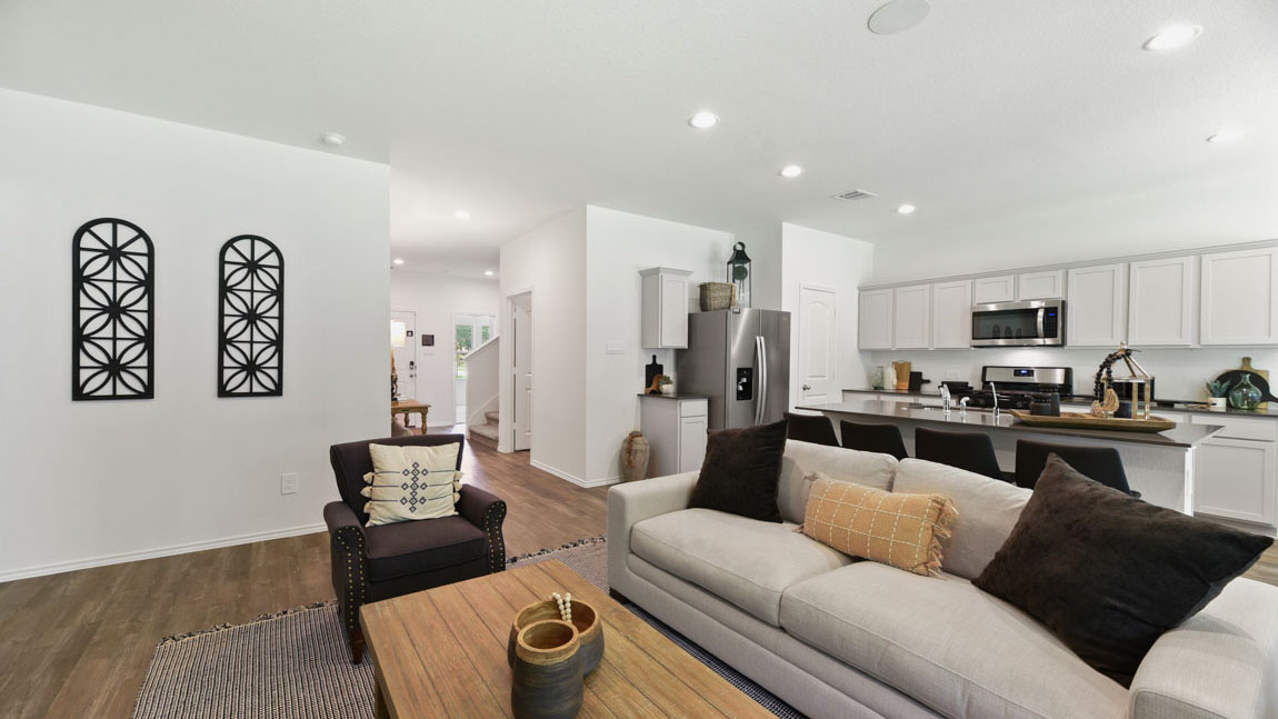 Spacious living area with vinyl flooring