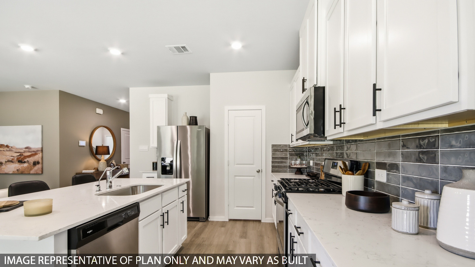 Kitchen with quartz countertops and marden hardware and an island and vinyl floor