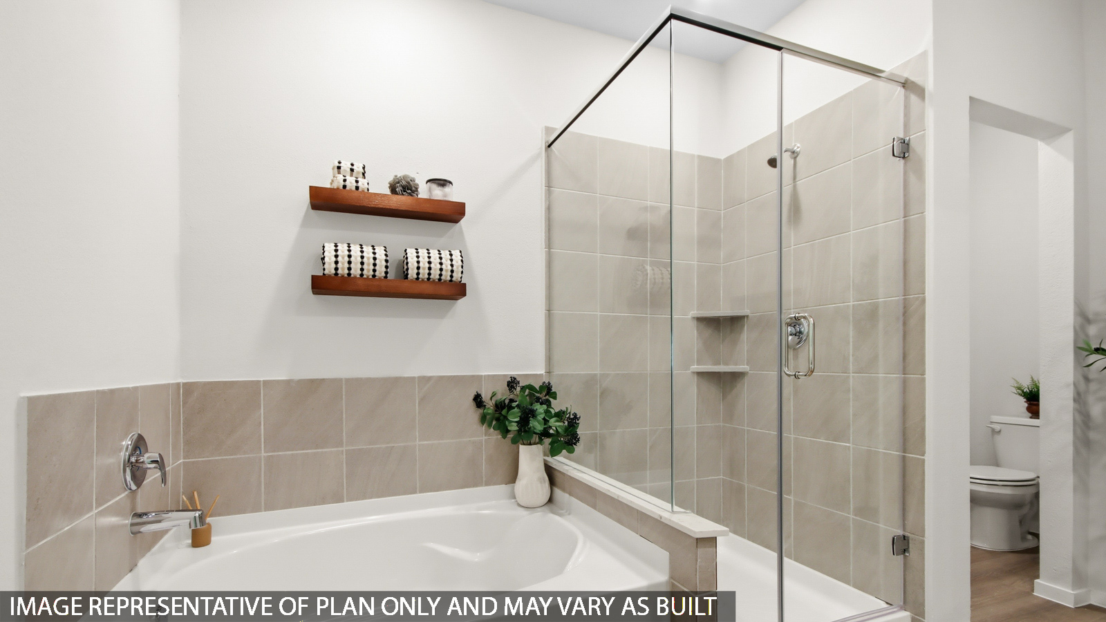 Primary bathroom with tile shower and semi-frameless glass and separate toilet room in Magnolia TX