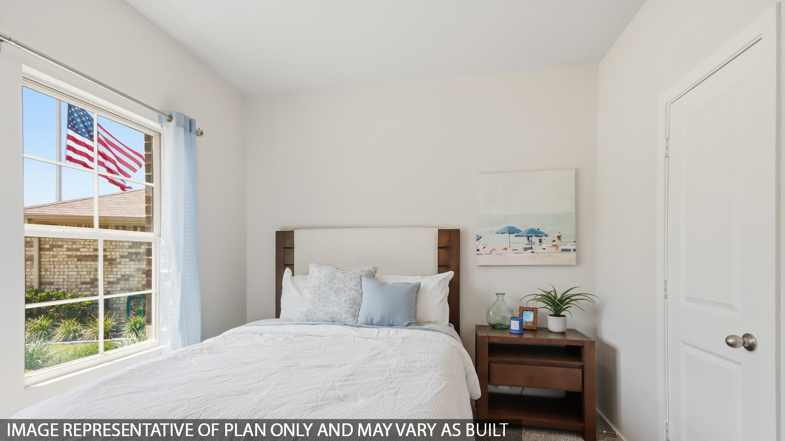 Secondary bedroom with shag carpet flooring and bright window