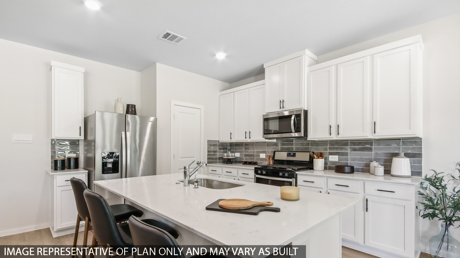 Kitchen with quartz countertops and marden hardware and an island and vinyl floor