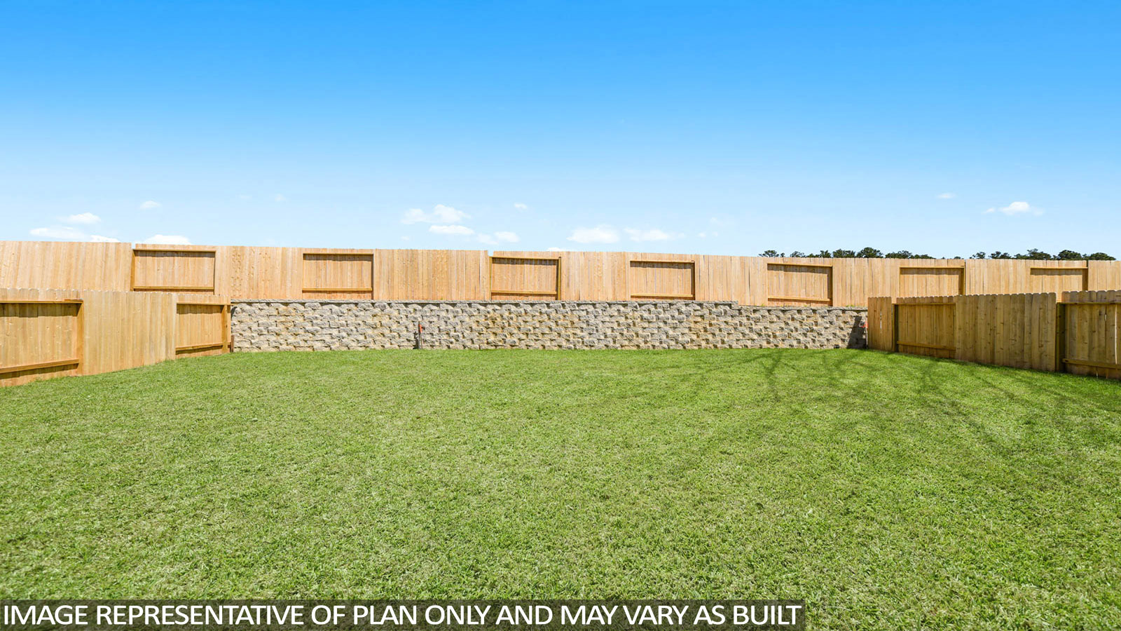 Landscaped backyard with a covered patio.