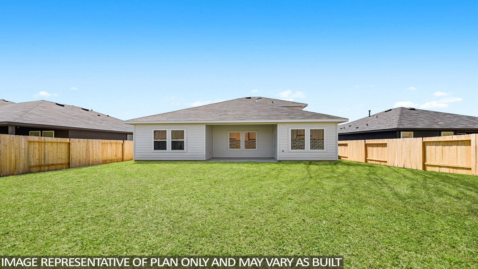 Landscaped backyard with a covered patio.