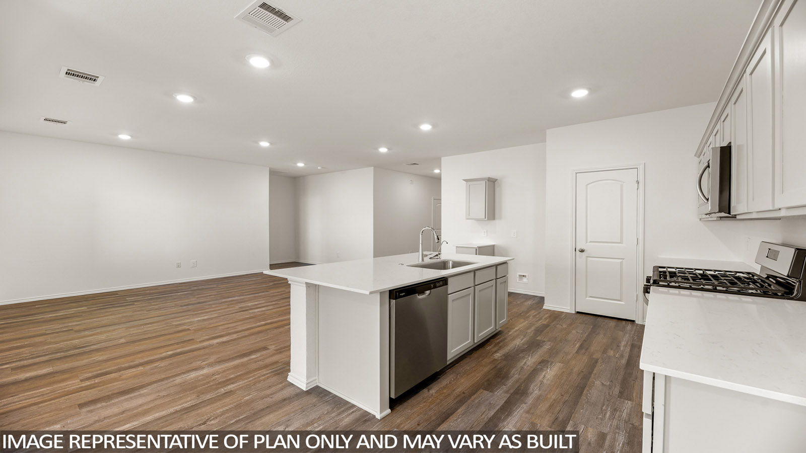 Open kitchen with an island, stainless steel appliances, white cabinets, white walls, and vinyl wood flooring.