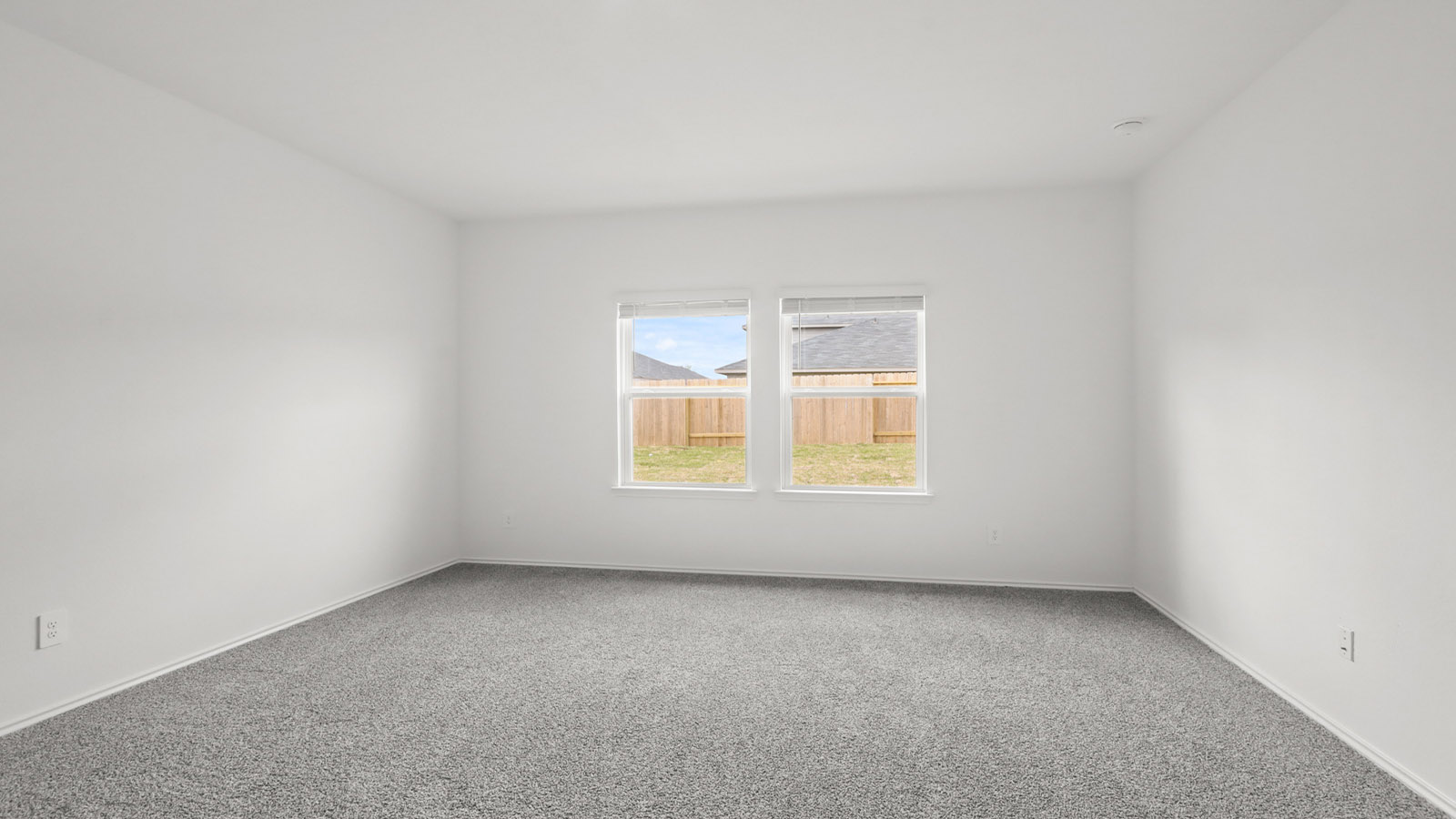 Large Primary bedroom with shag carpet flooring and bright window