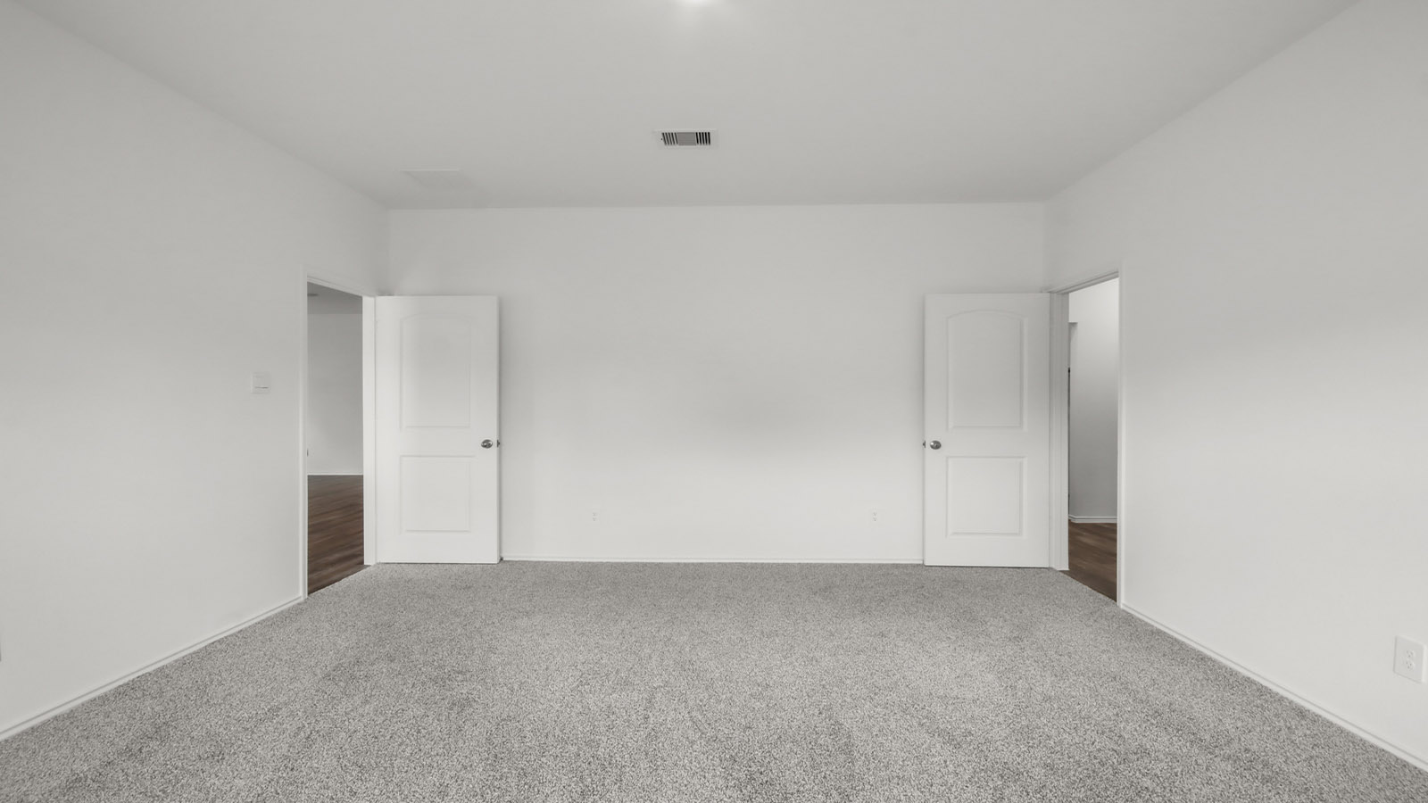 Large Primary bedroom with shag carpet flooring and bright window