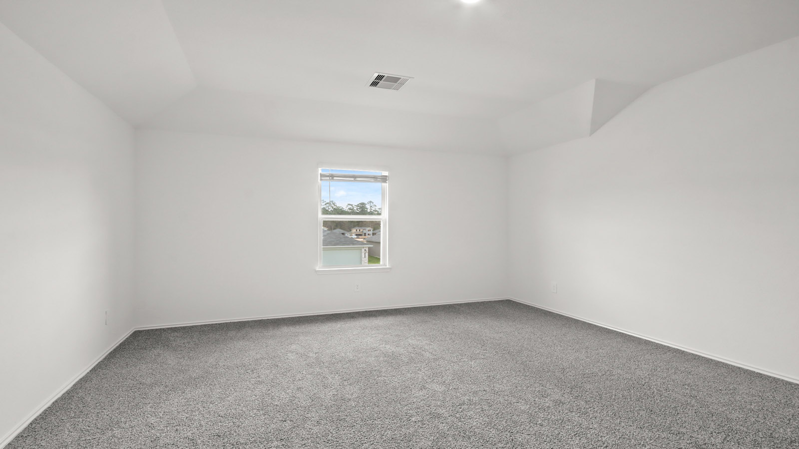 Secondary bedroom with shag carpet flooring and bright window