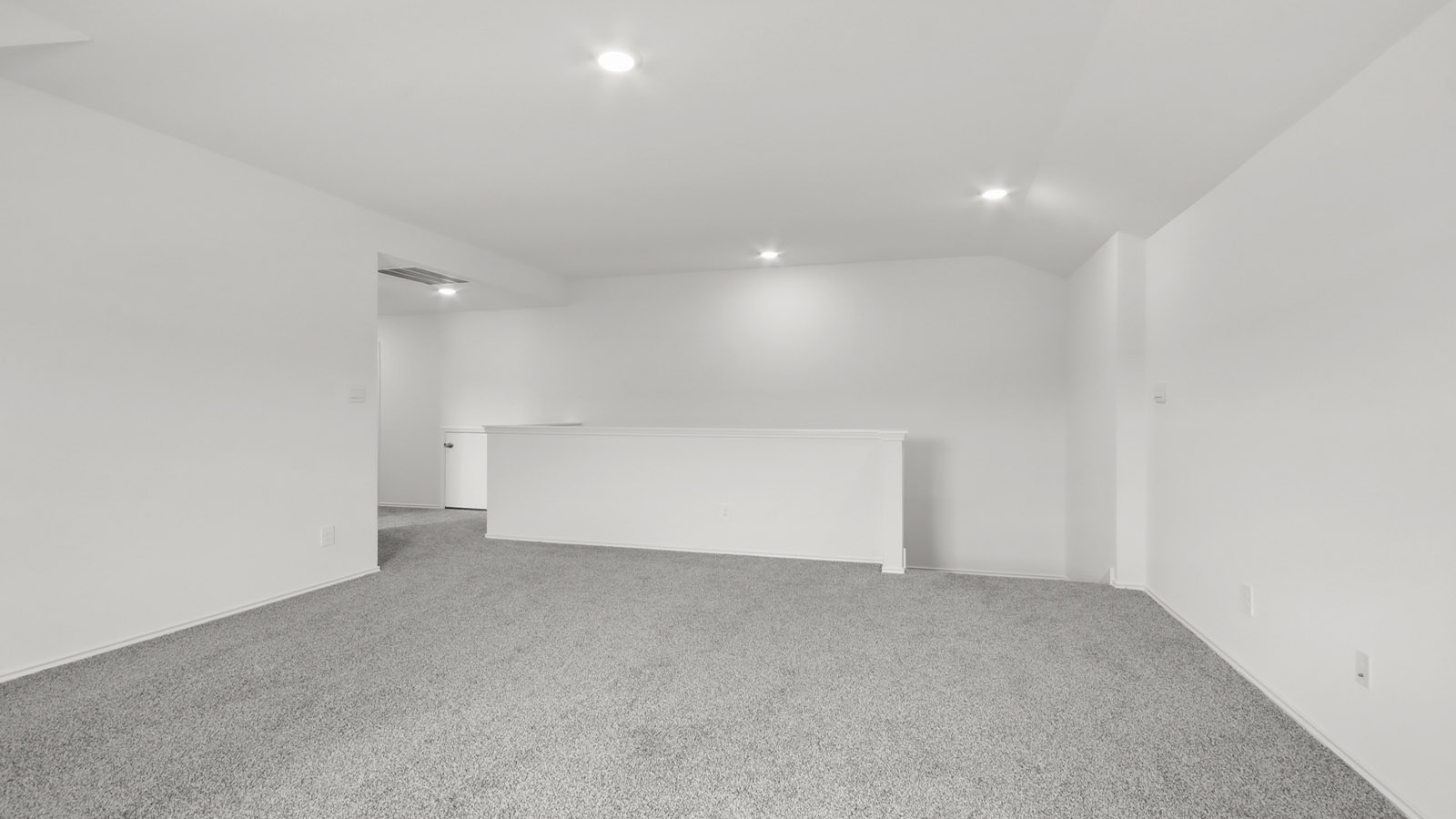 Second story game room with carpet flooring with bright windows in this multi functional space in Magnolia TX