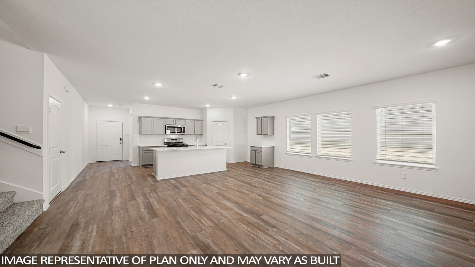 Spacious living area with vinyl flooring