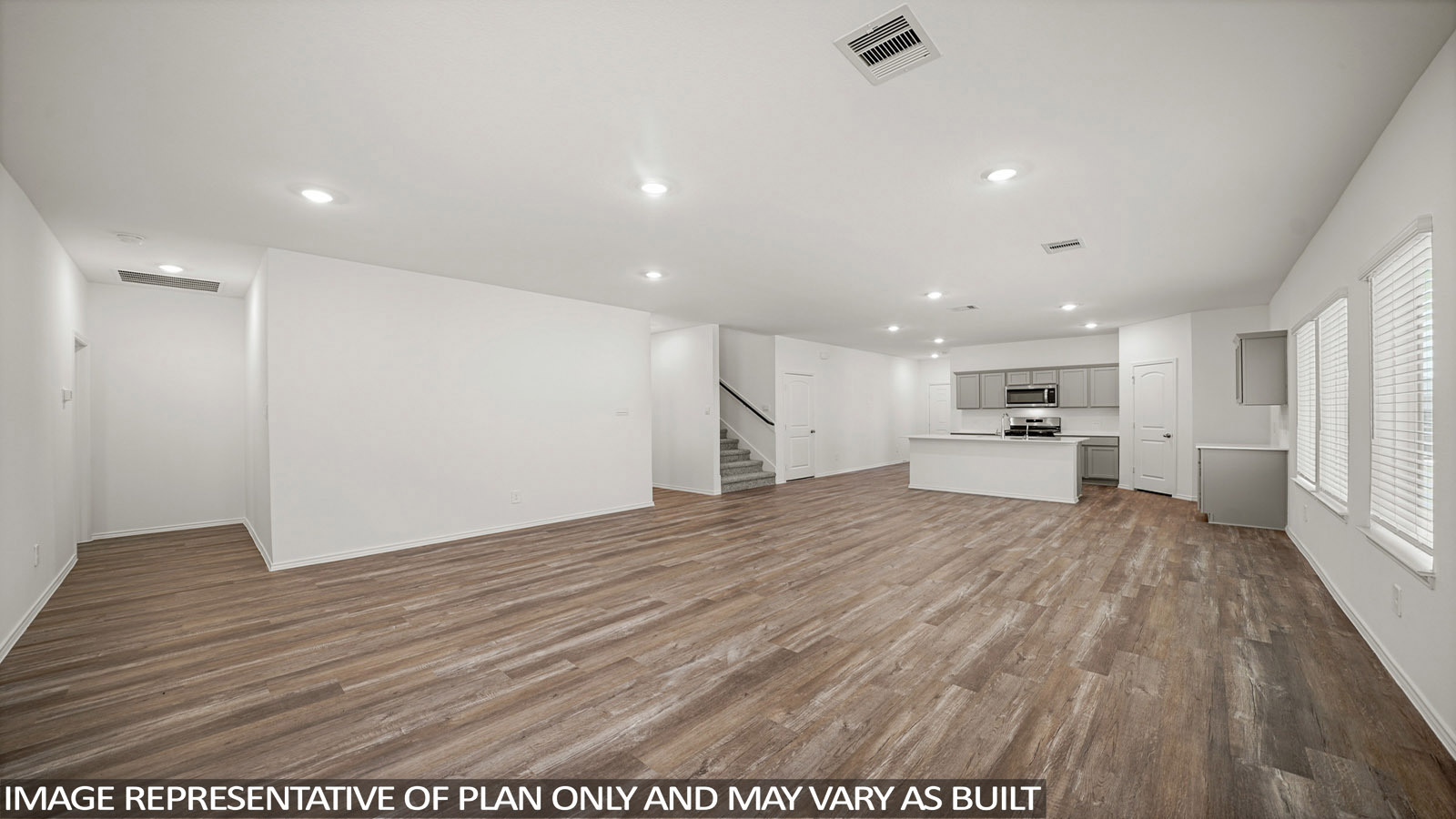 Spacious living area with vinyl flooring