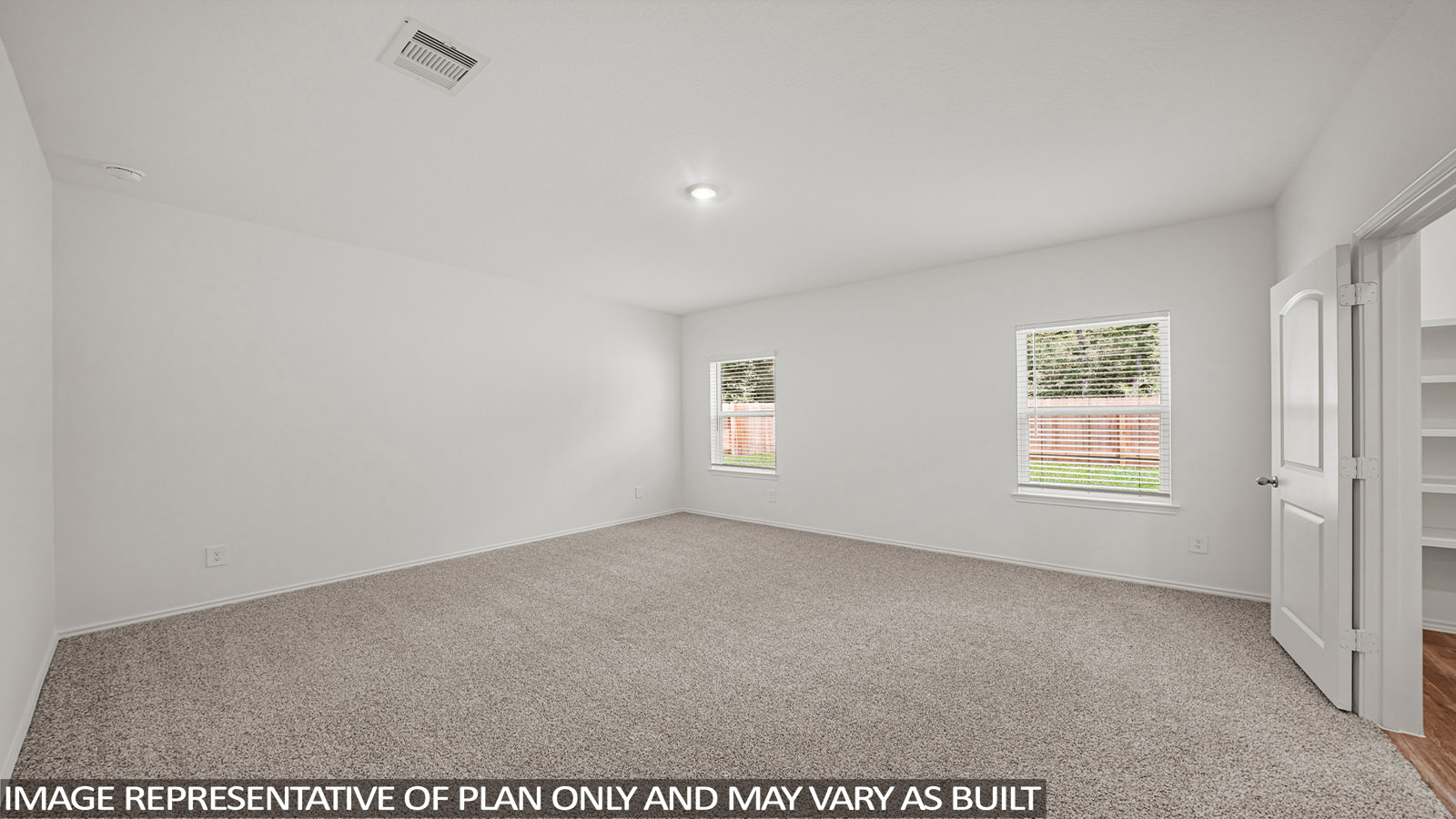 Primary bedroom with carpet flooring