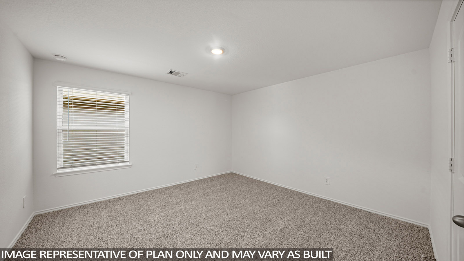 Secondary bedroom with carpet flooring