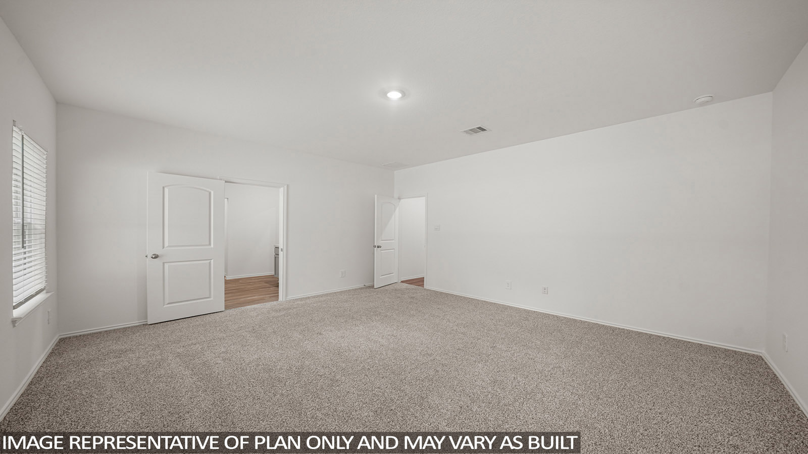 Primary bedroom with carpet flooring