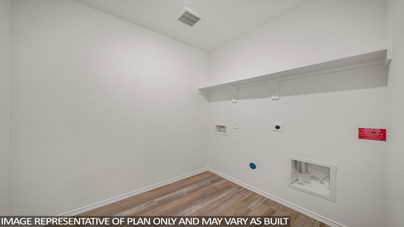 Utility room with storage located off the entry hallway and garage door