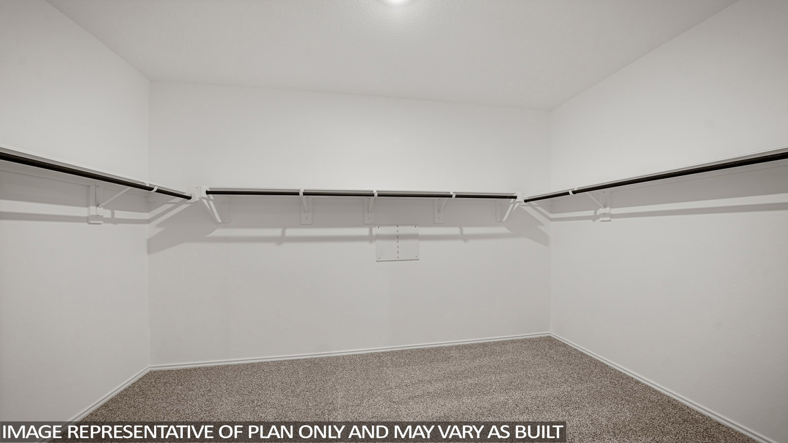 Primary bedroom walk-in closet with carpet flooring in Mill Creek community in Magnolia TX
