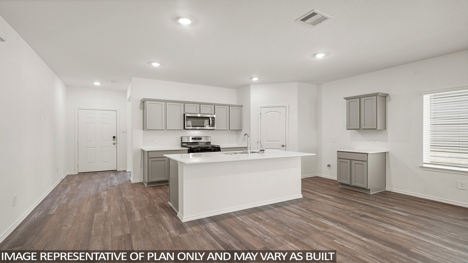 Kitchen with quartz countertops and marden hardware and an island and vinyl floor