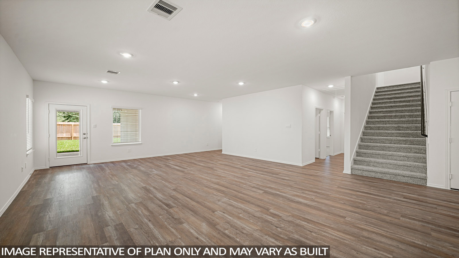 Spacious living area with vinyl flooring and bright windows in Magnolia TX