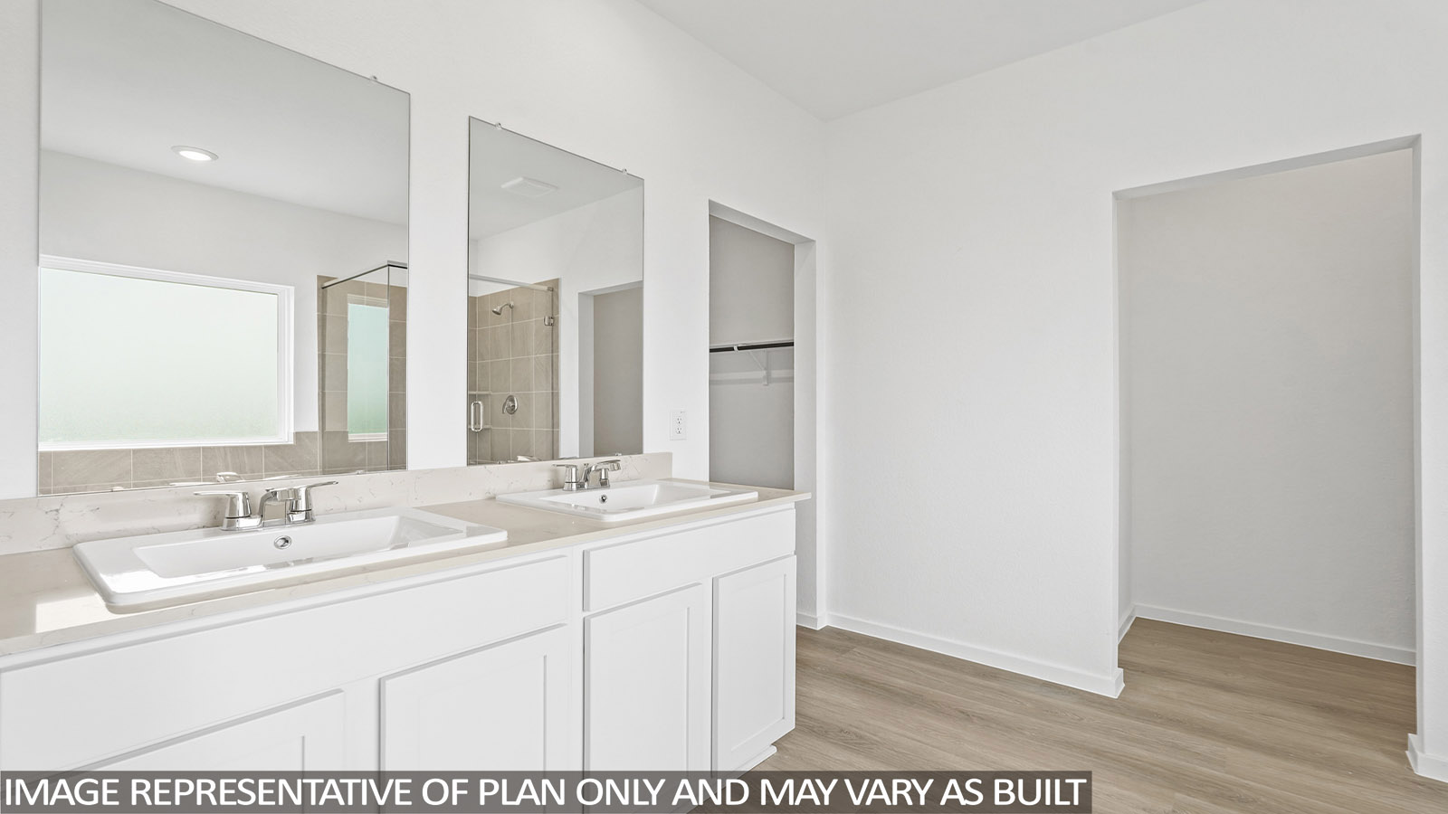 Primary bathroom with double sinks with quartz counter tops in Magnolia TX