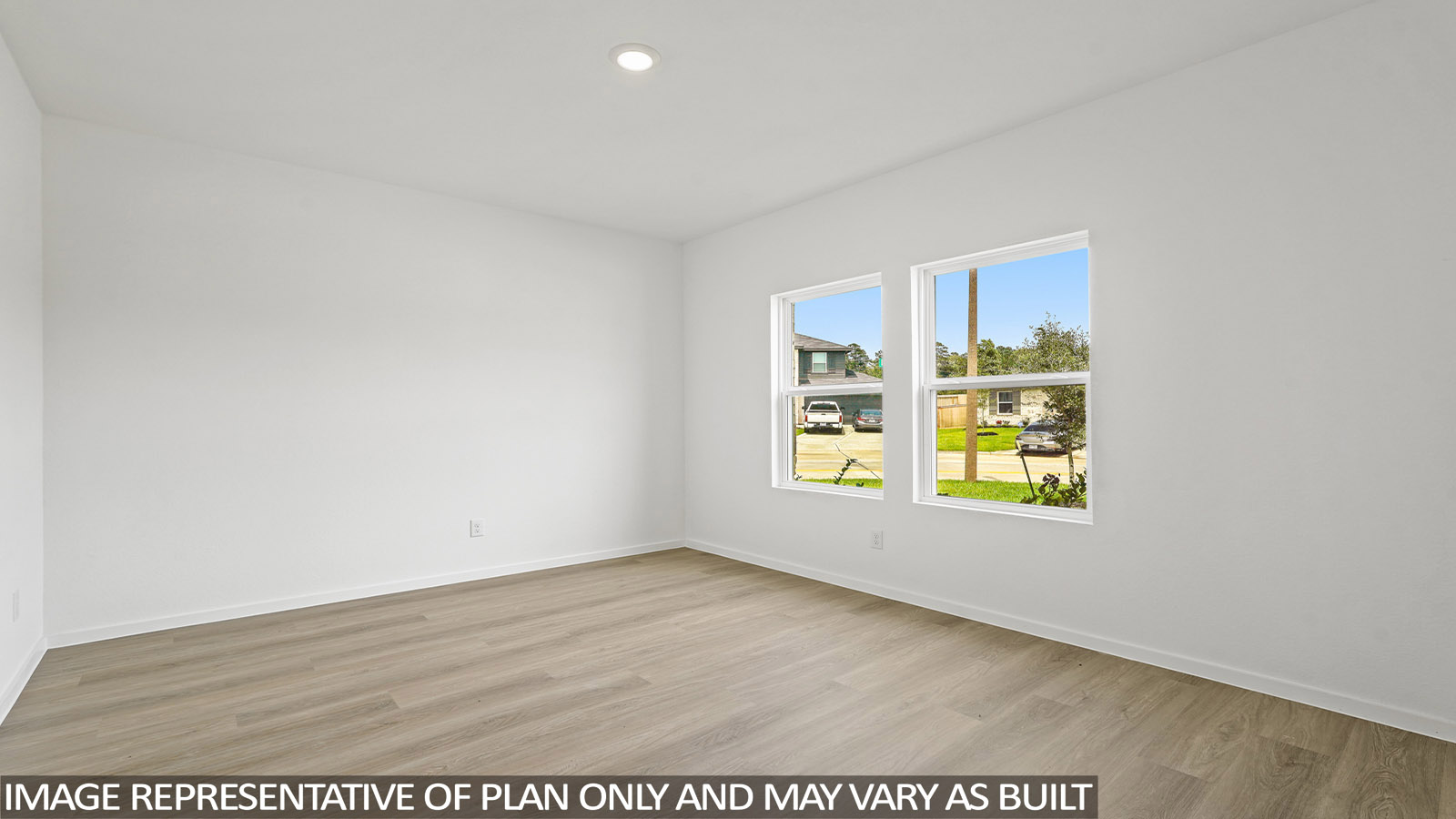Spacious living area with vinyl flooring and bright windows in Magnolia TX