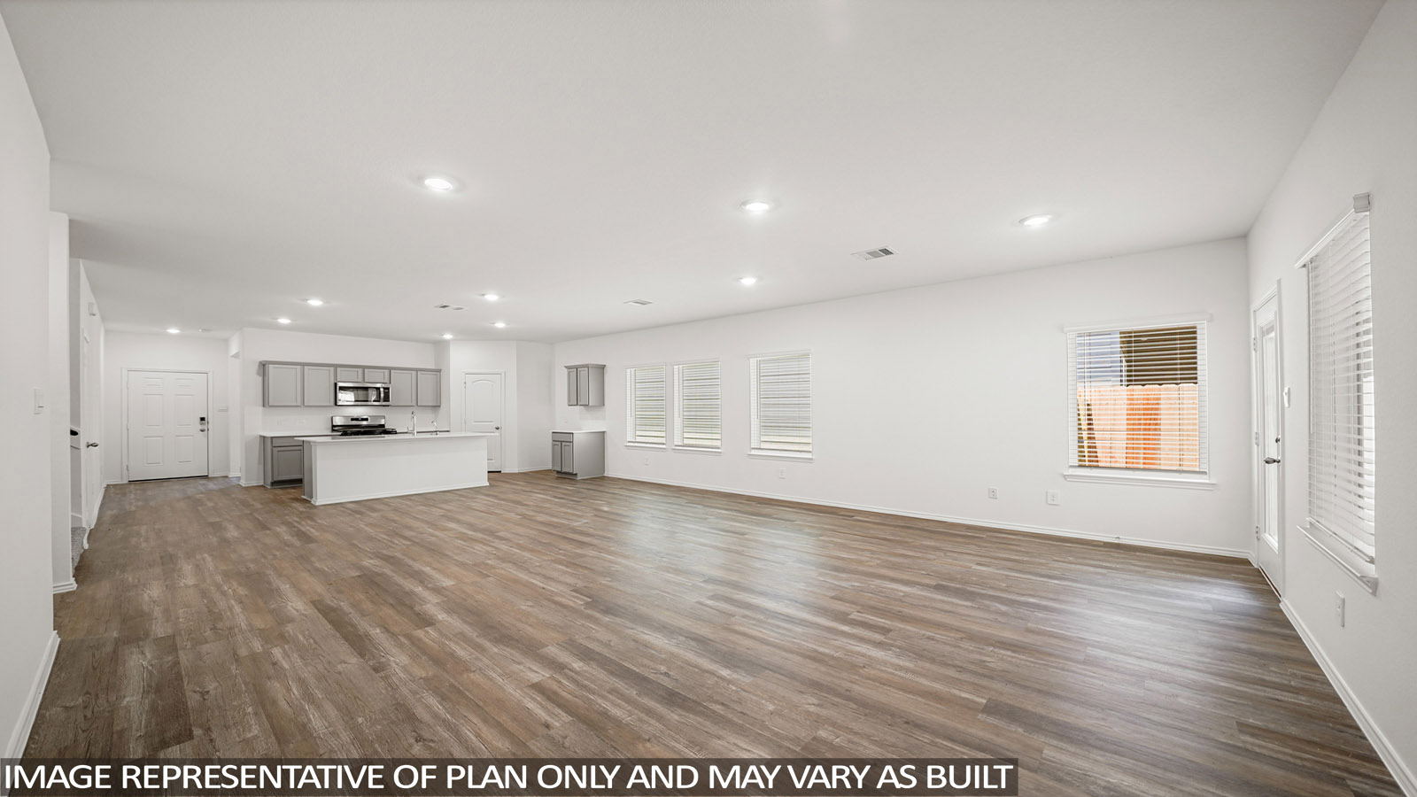 Spacious living area with vinyl flooring