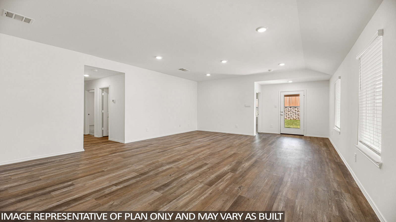 Spacious living area with vinyl flooring