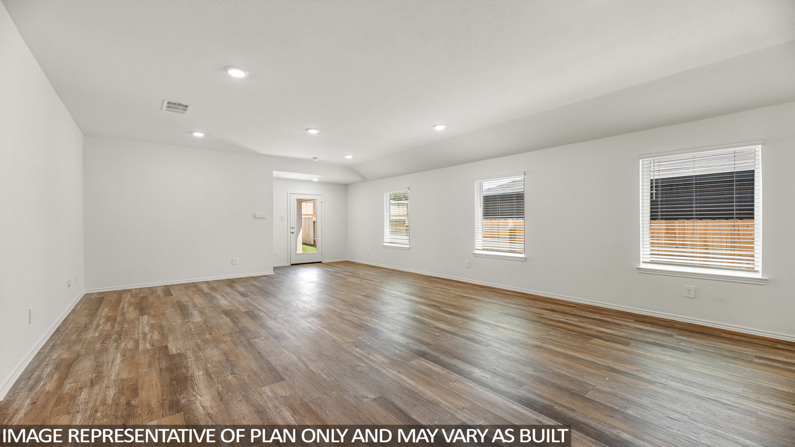 Spacious living area with vinyl flooring