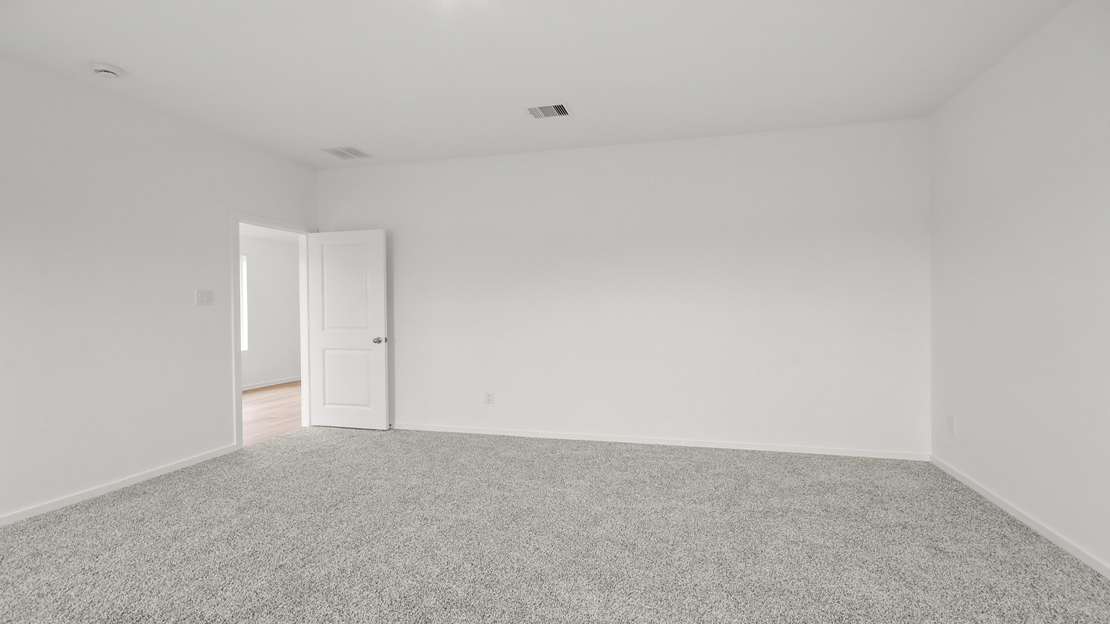 Large Primary bedroom with shag carpet flooring and bright window