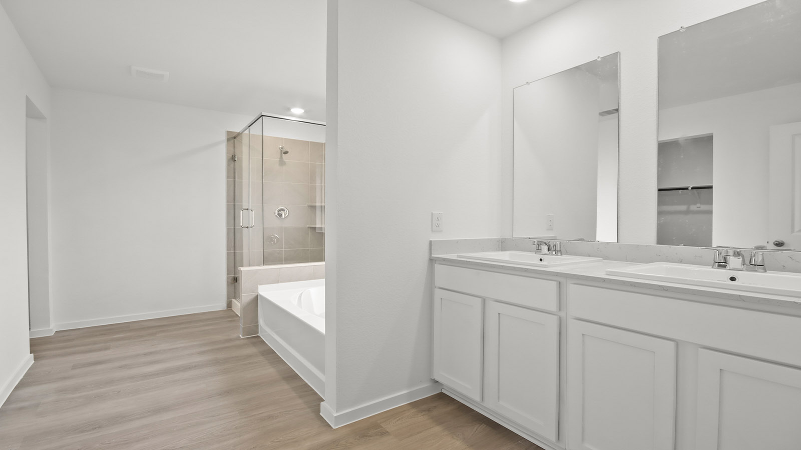 Primary bathroom with double sinks with quartz counter tops in Magnolia TX