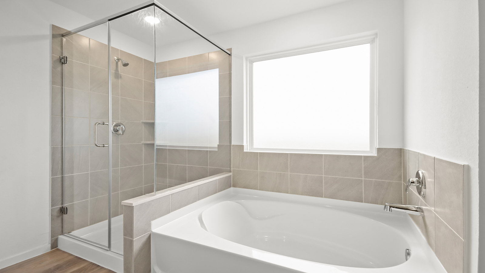 Primary bathroom with tile shower and semi-frameless glass and separate toilet room in Magnolia TX