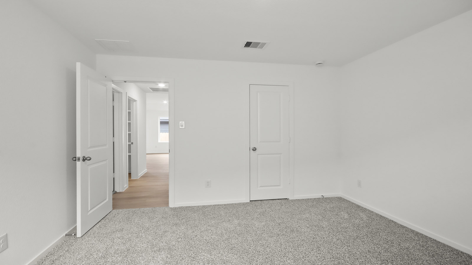 Secondary bedroom with shag carpet flooring and bright window