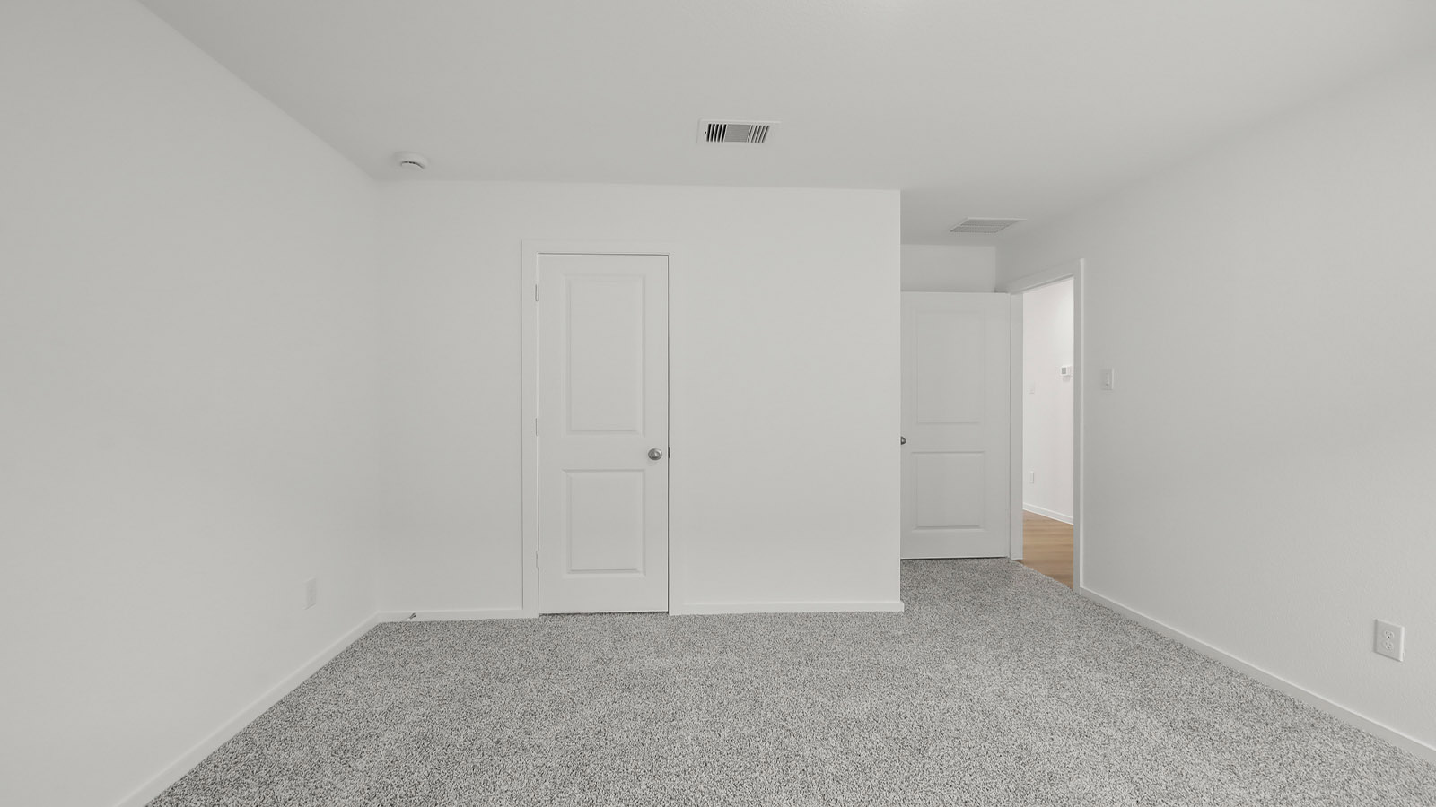 Secondary bedroom with shag carpet flooring and bright window