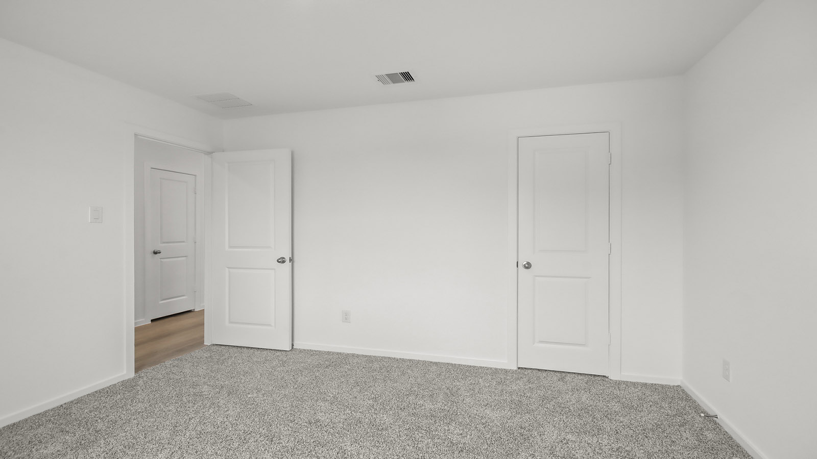 Secondary bedroom with shag carpet flooring and bright window