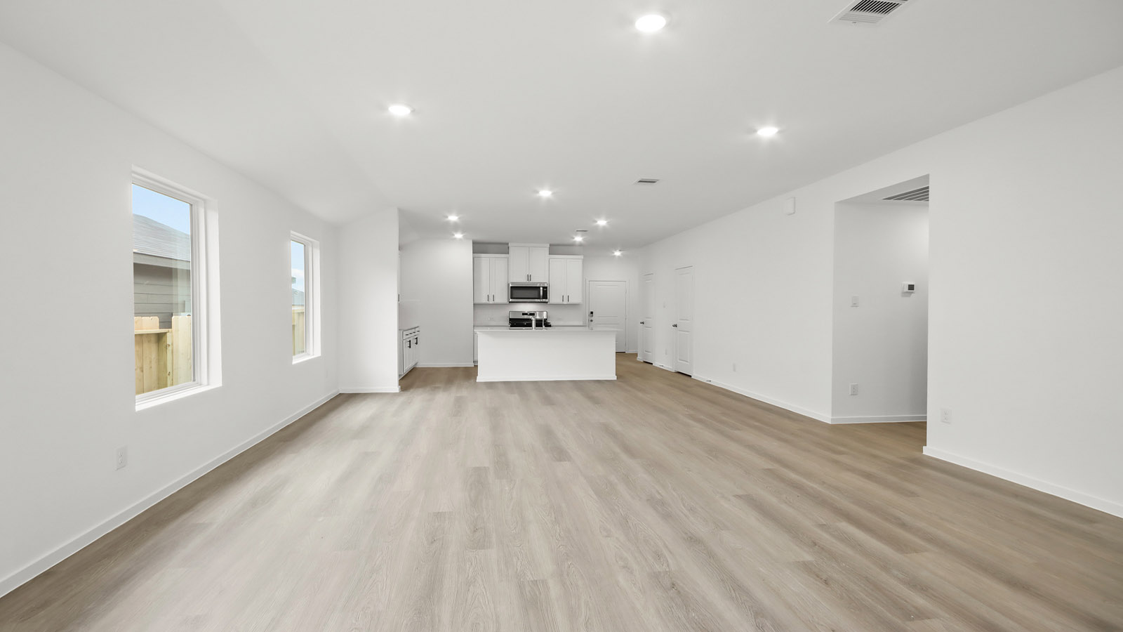 Spacious living area with vinyl flooring and bright windows in Magnolia TX