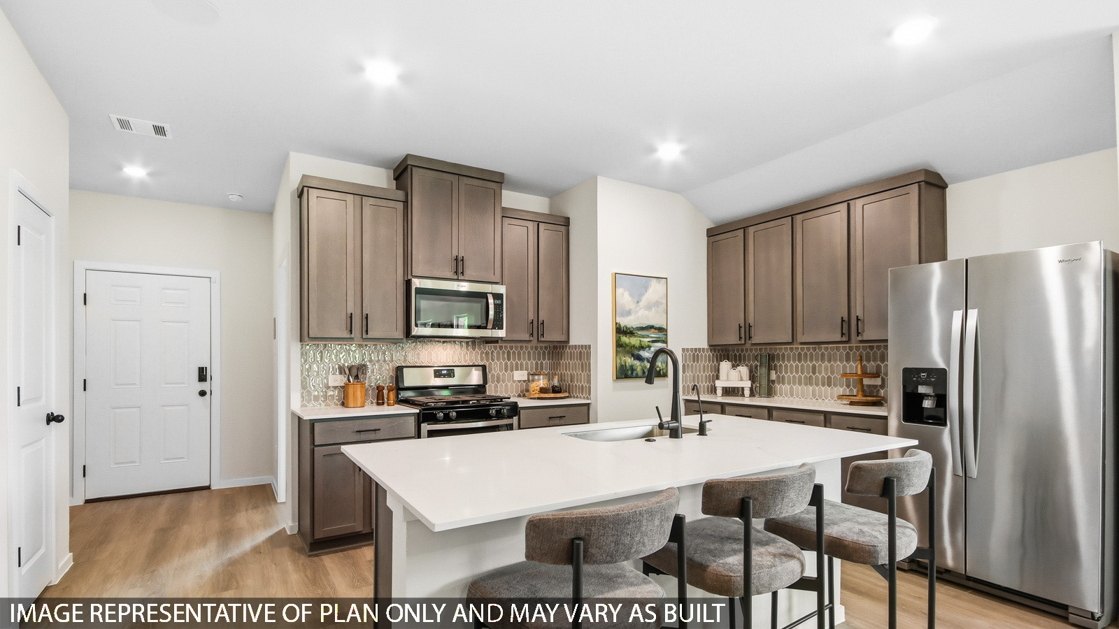 Kitchen with quartz countertops and marden hardware and an island and vinyl floor