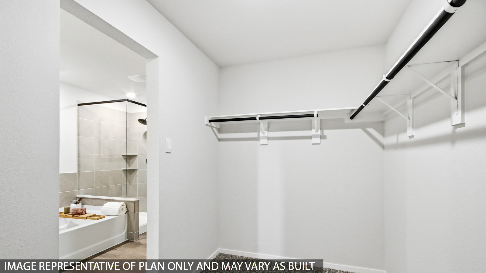 Primary bedroom walk-in closet with carpet flooring in Mill Creek community in Magnolia TX