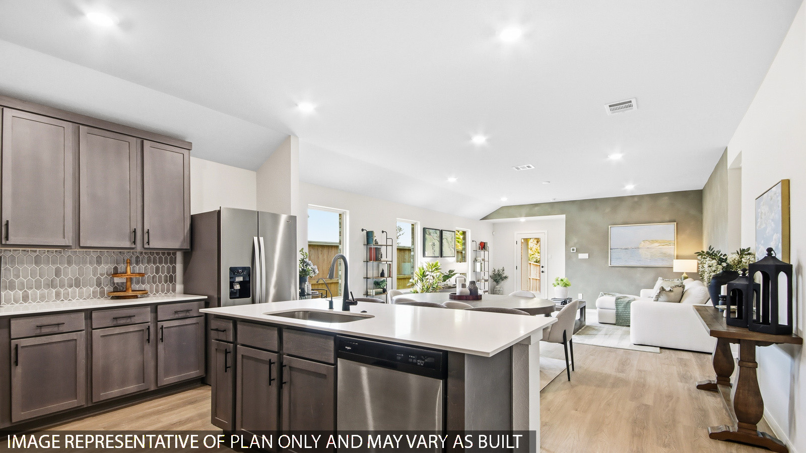 Kitchen with quartz countertops and marden hardware and an island and vinyl floor