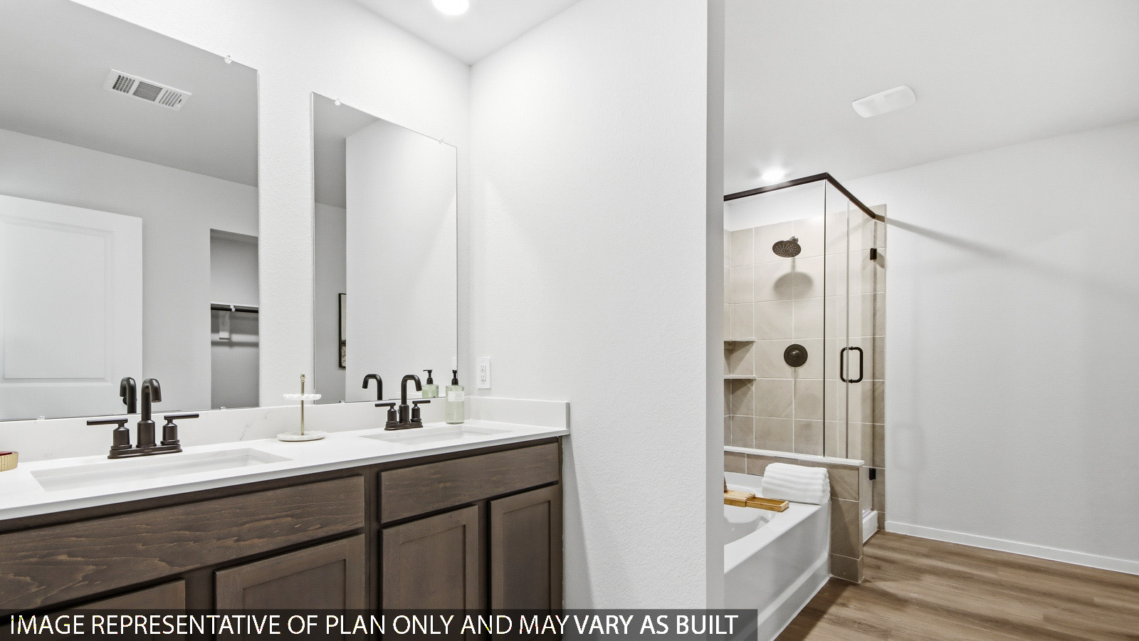 Primary bathroom with soaker tub and tile shower with semi frameless glass in Magnolia TX