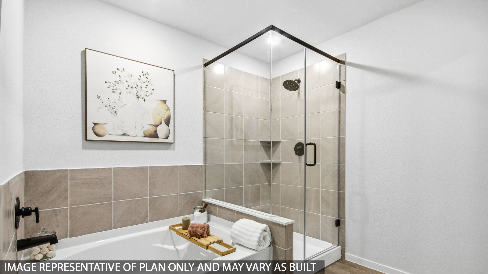 Primary bathroom with soaker tub and tile shower with semi frameless glass in Magnolia TX