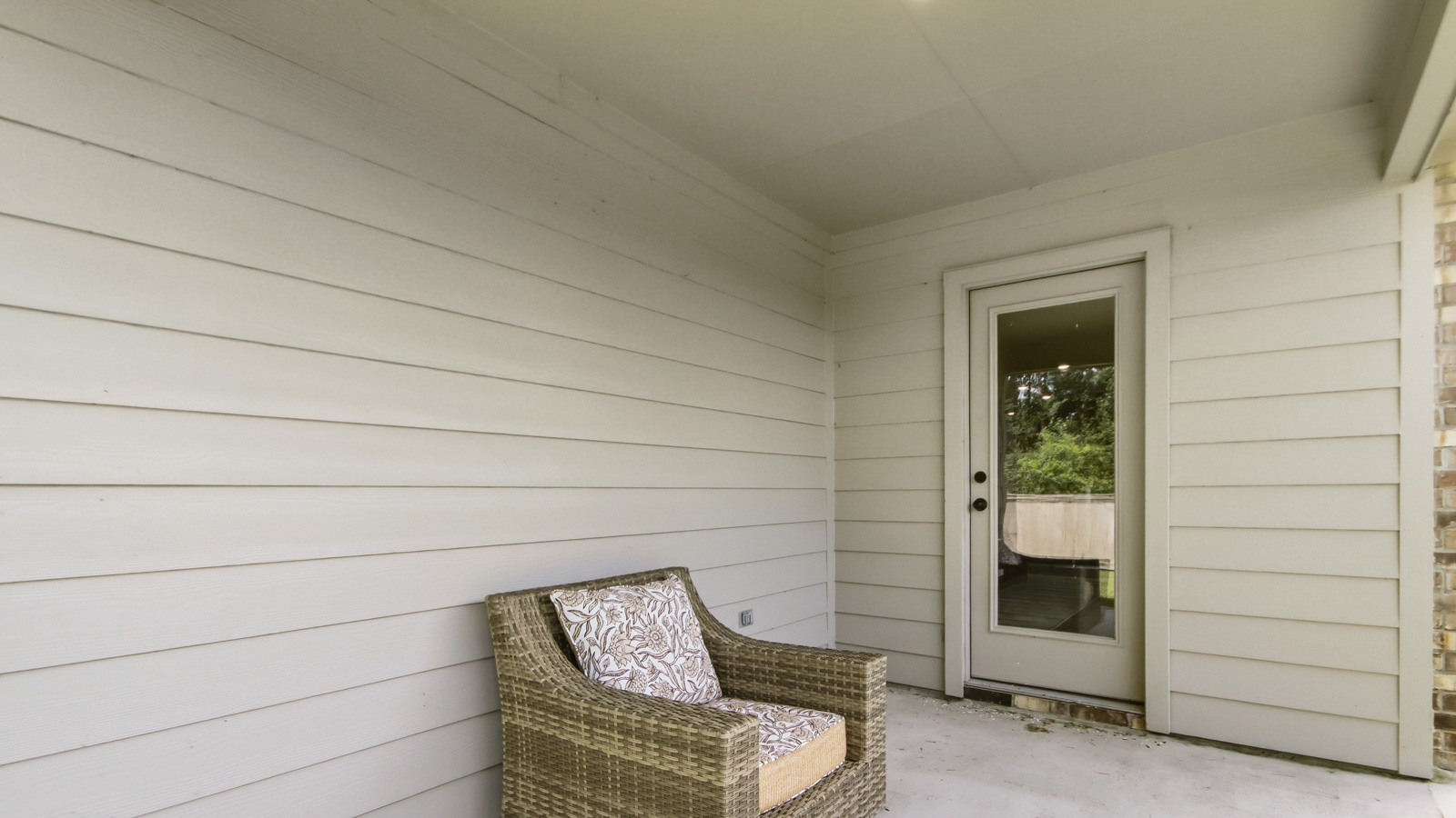 covered patio with jamies hardie siding and overhead lighting