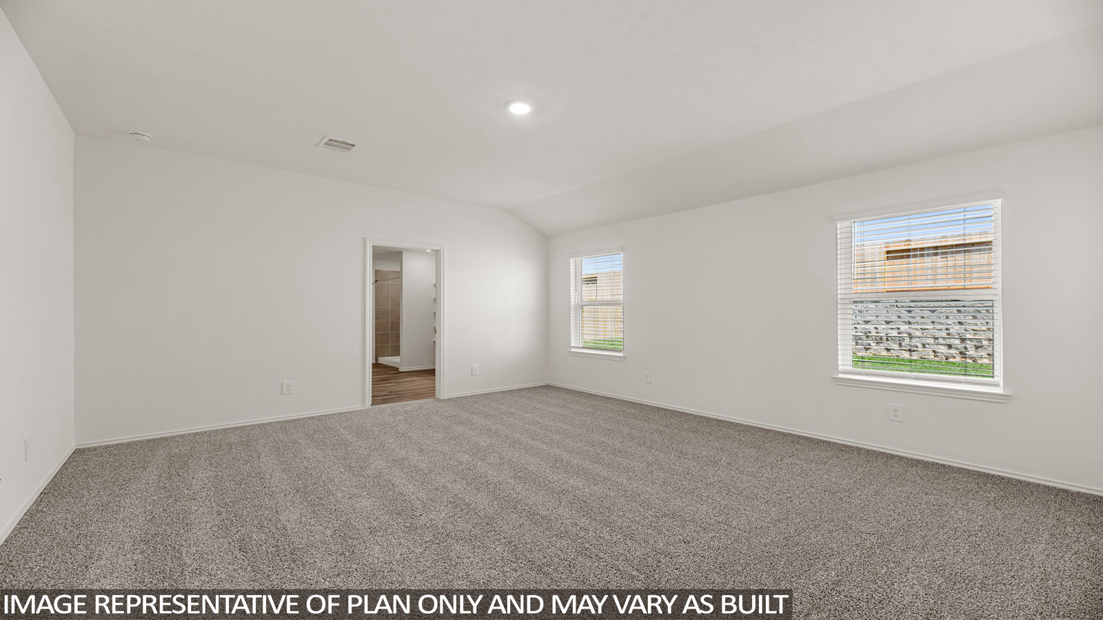 Primary bedroom with windows, white walls, and light carpet.