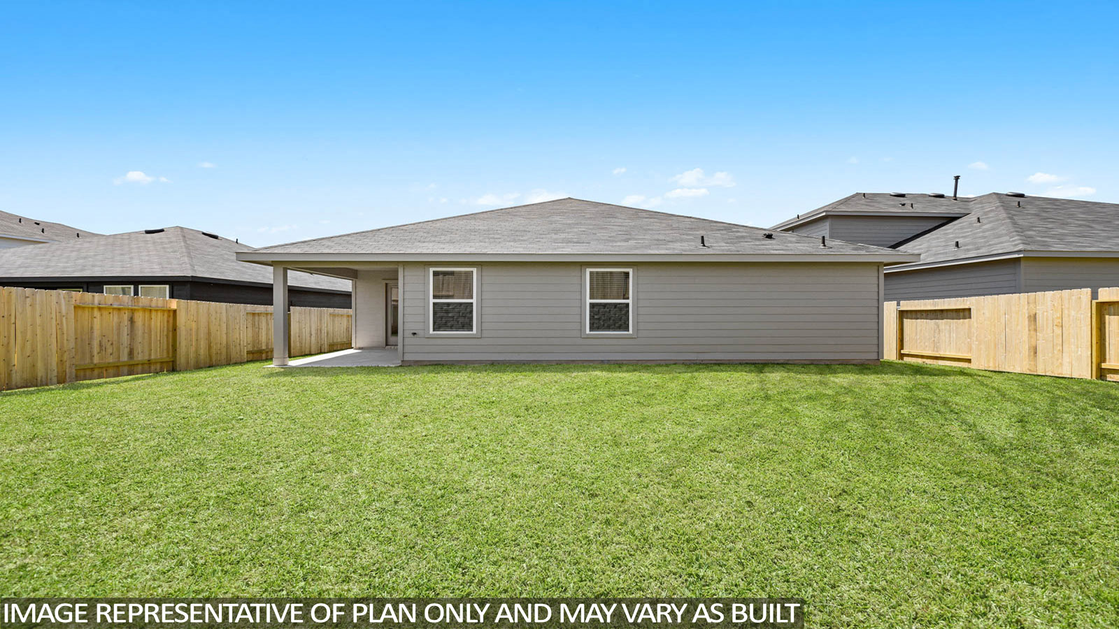 Landscaped backyard with a covered patio.