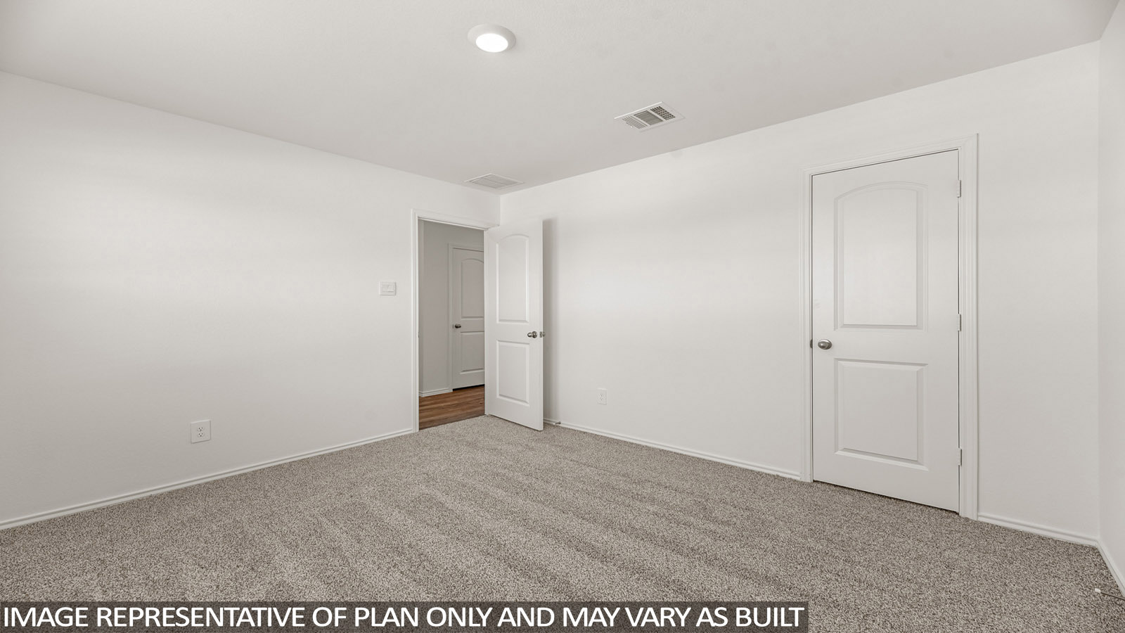 Secondary bedroom with windows, white walls, and light carpet.