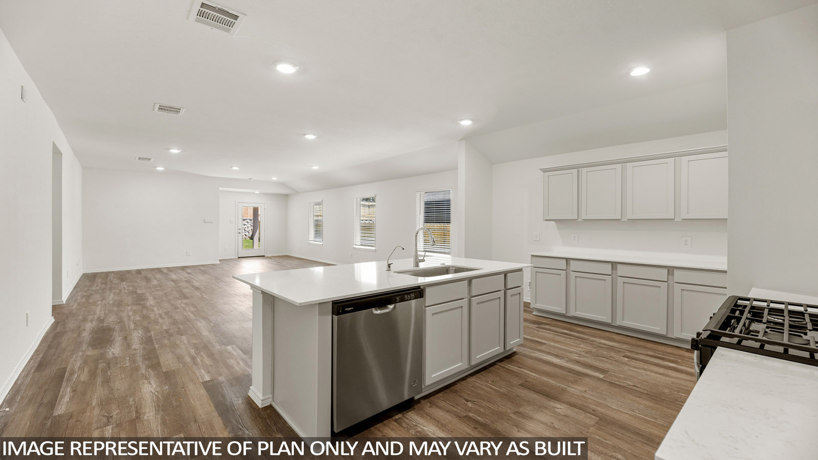 Open kitchen with an island, stainless steel appliances, white cabinets, white walls, and vinyl wood flooring.