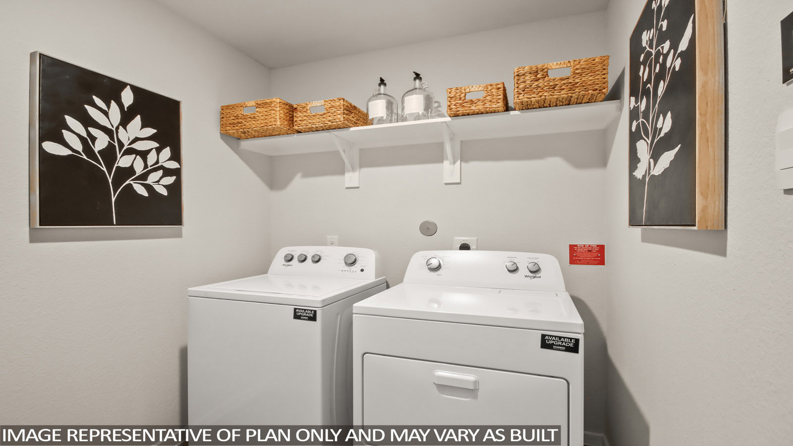 Utility room with storage located off the entry hallway and garage door