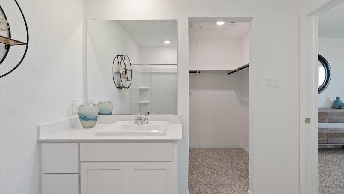 Primary bathroom with stand-alone shower with tiles and semi frameless glass in Magnolia TX