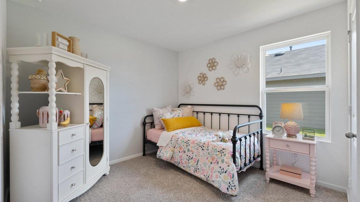 Secondary bedroom with shag carpet flooring and bright window